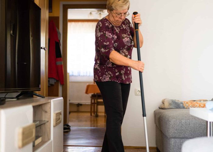 Retired senior woman at home, doing her daily chores. Old woman living alone in a house. Seniors.